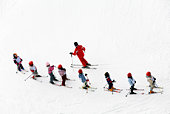 Aerial shot of a group of young skiers and instructor