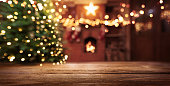 Christmas Tree With Illumination Near the Fireplace. Home Decor