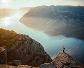 Woman hiking in mountains on the background of Lysefjorden