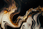 High resolution. Luxury abstract fluid art painting in alcohol ink technique, mixture of black, gray and gold paints. Imitation of marble stone cut, glowing golden veins. Tender and dreamy design.