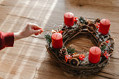 Advent wreath made with branches with four candles lit every sunday before christmas.