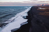 View of the black sand beach coastline from the top