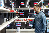 Young man shopping for electronics during a Black Friday sale
