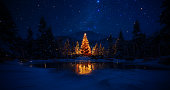 Fairy Winter Scene with Illuminated Christmas Tree and Starry Sky