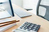 Close up of a modern office desk with computer keyboard and calculator