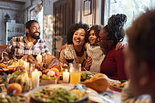 Happy black girl enjoying with her family during lunch on Thanksgiving.