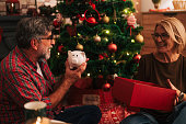 Mature couple exchanging financial gift on christmas