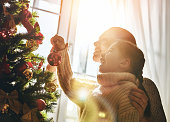 Mom and daughter decorate the Christmas tree