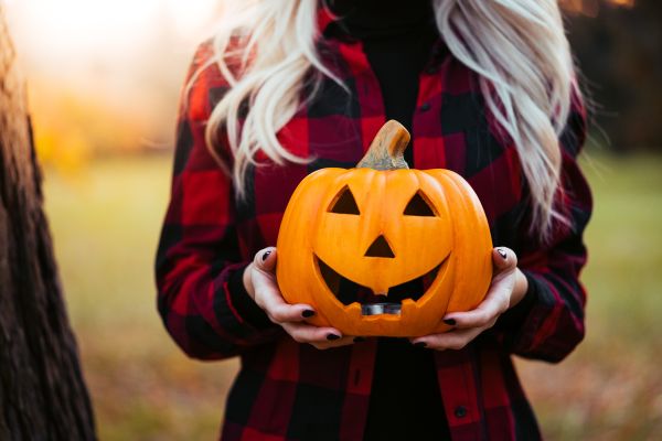 Woman Holding a Carved Halloween Pumpkin Free Photo